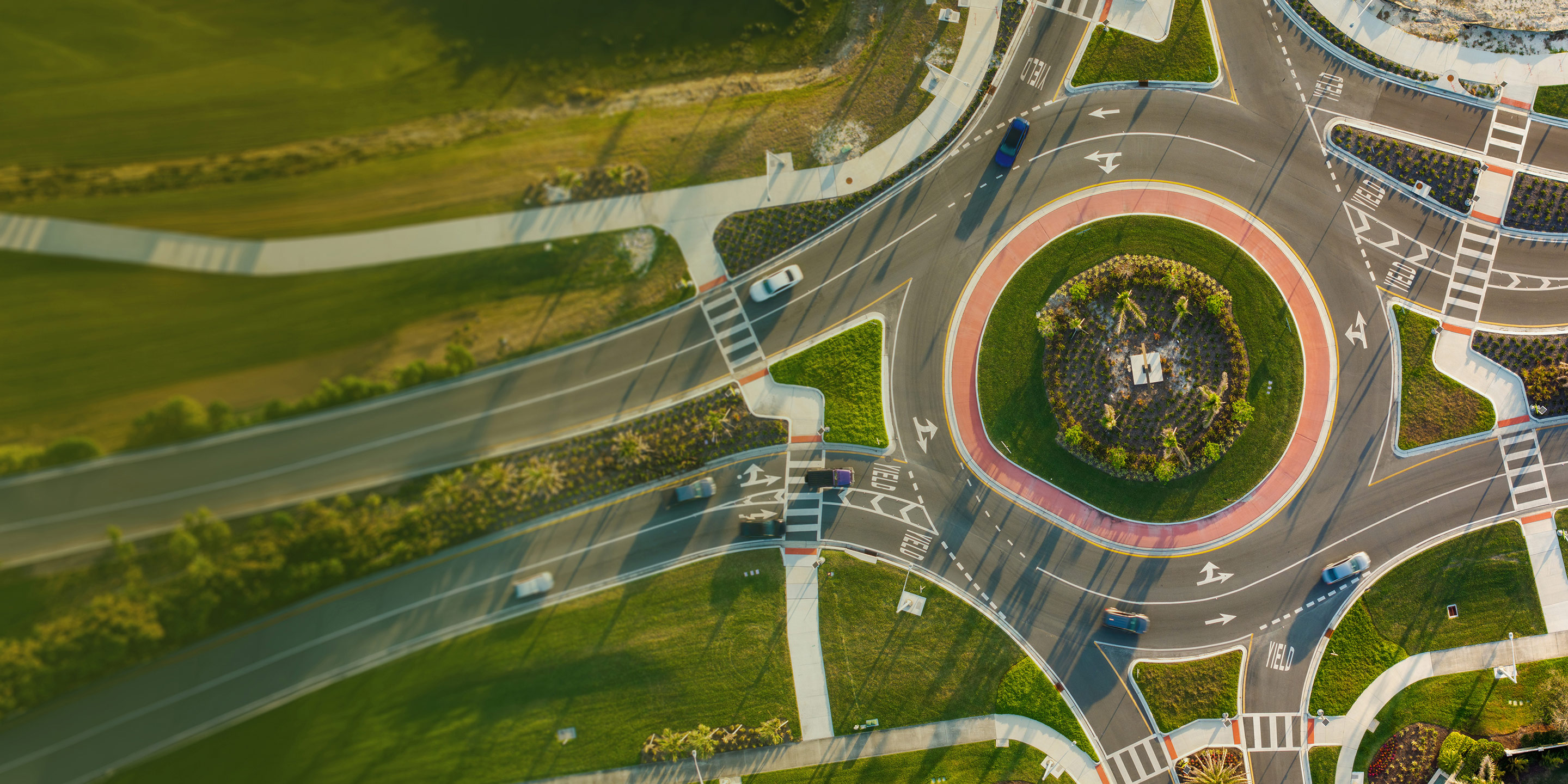 Aerial view of a modern roundabout with cars, a key visual for Trimble’s "Confidence at every turn" campaign for infrastructure solutions.