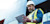 Man in reflective vest and hard hat using tablet in front of building