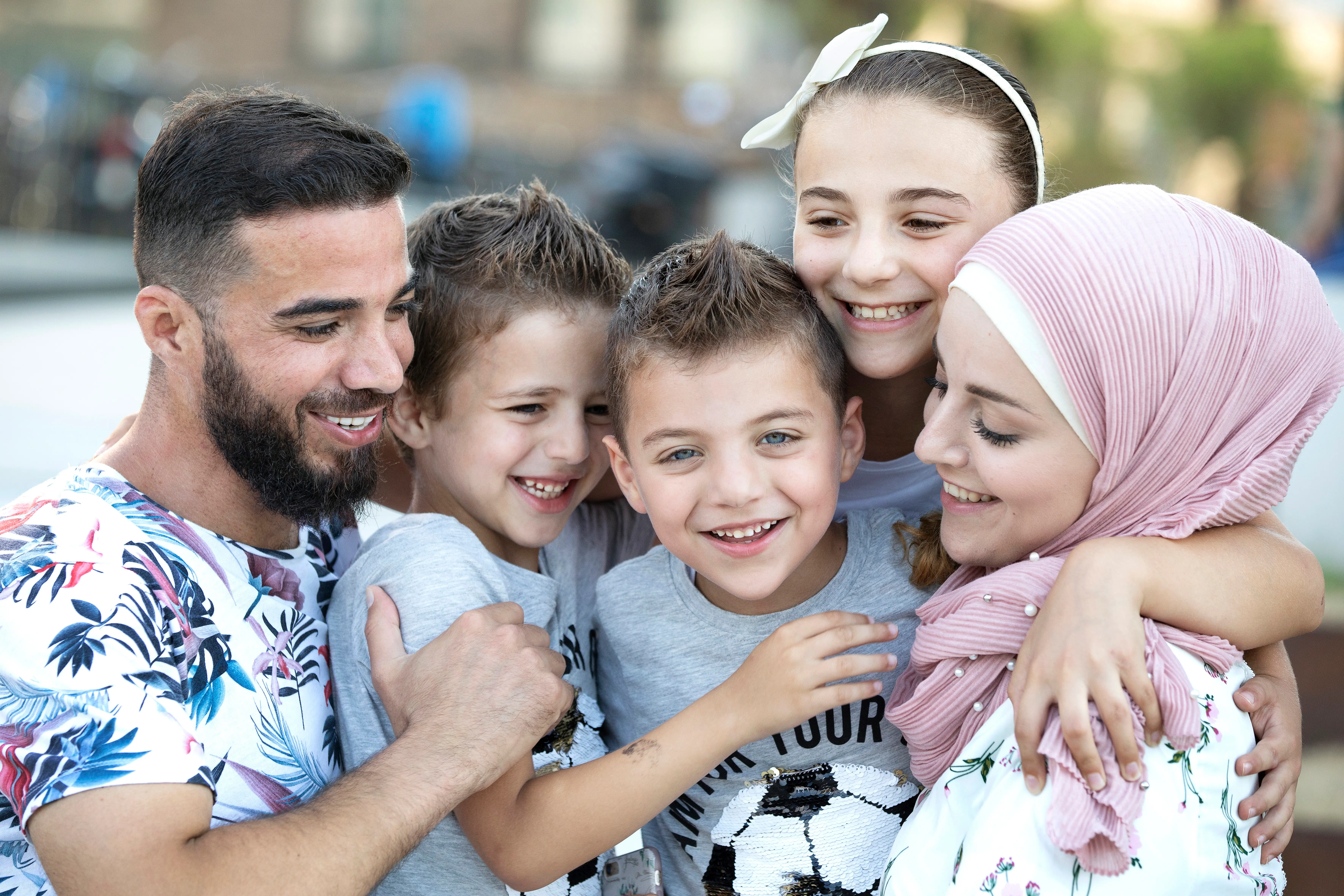 A family hugs each other.