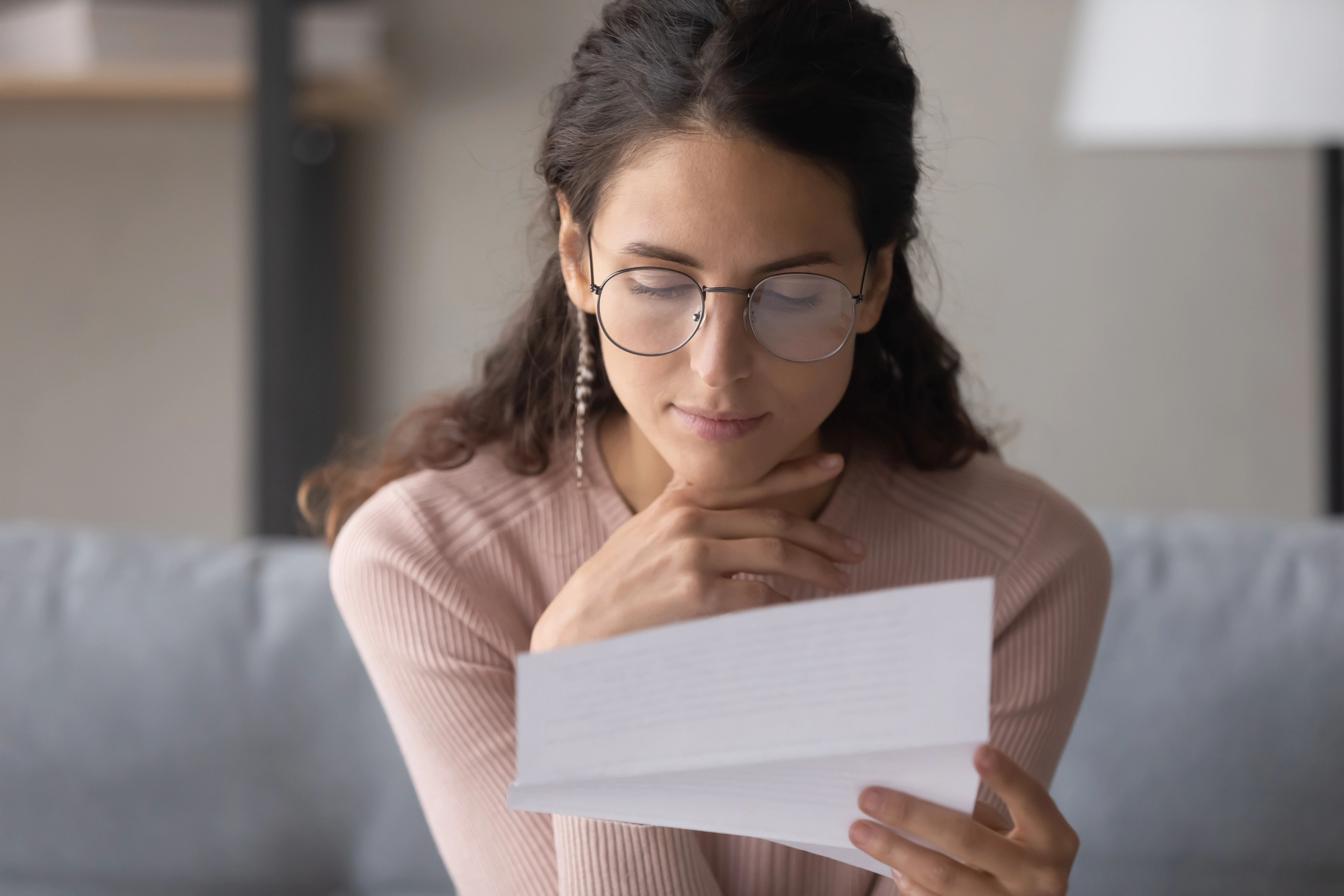 A woman reads a letter.