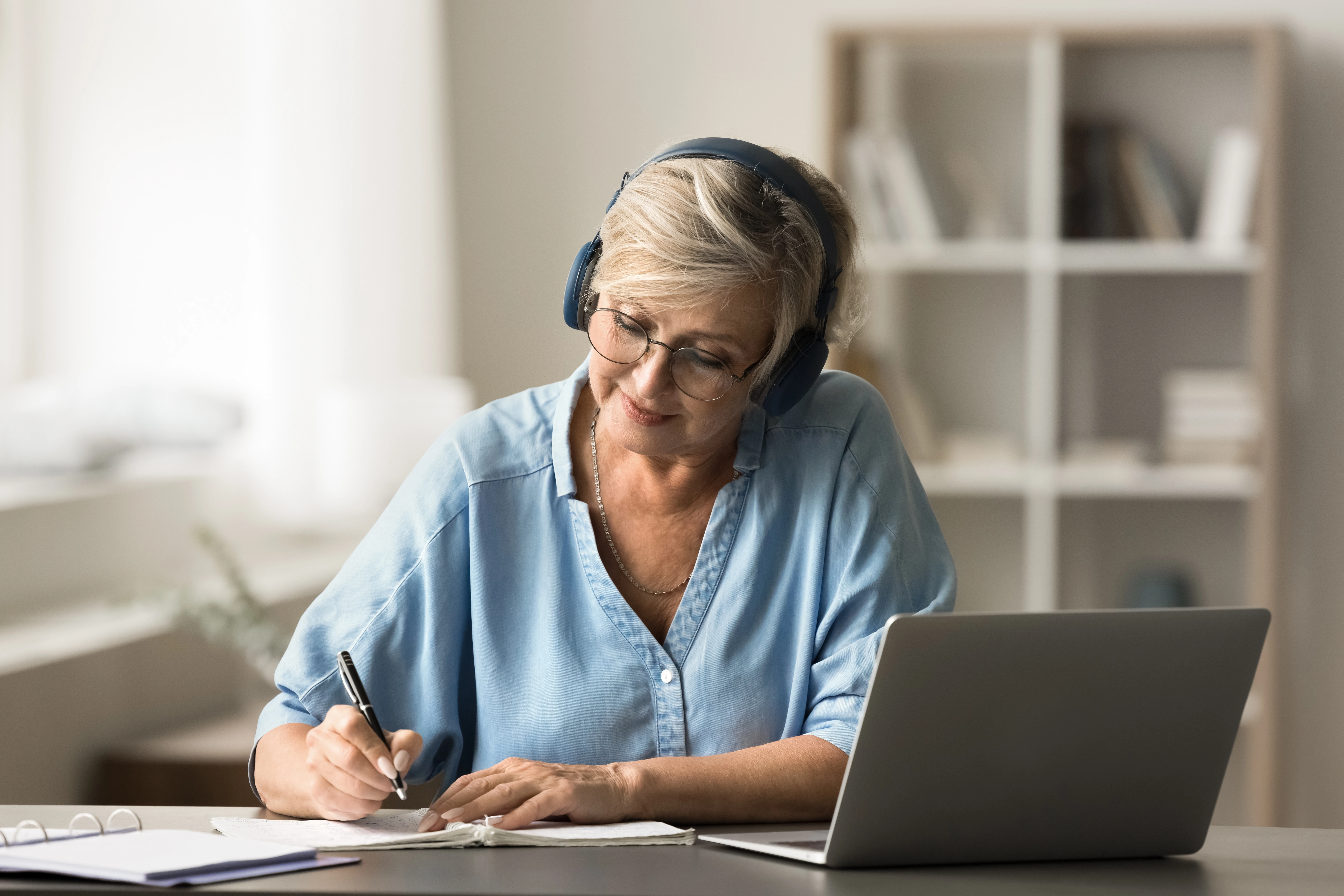 Woman follows an online webinar.