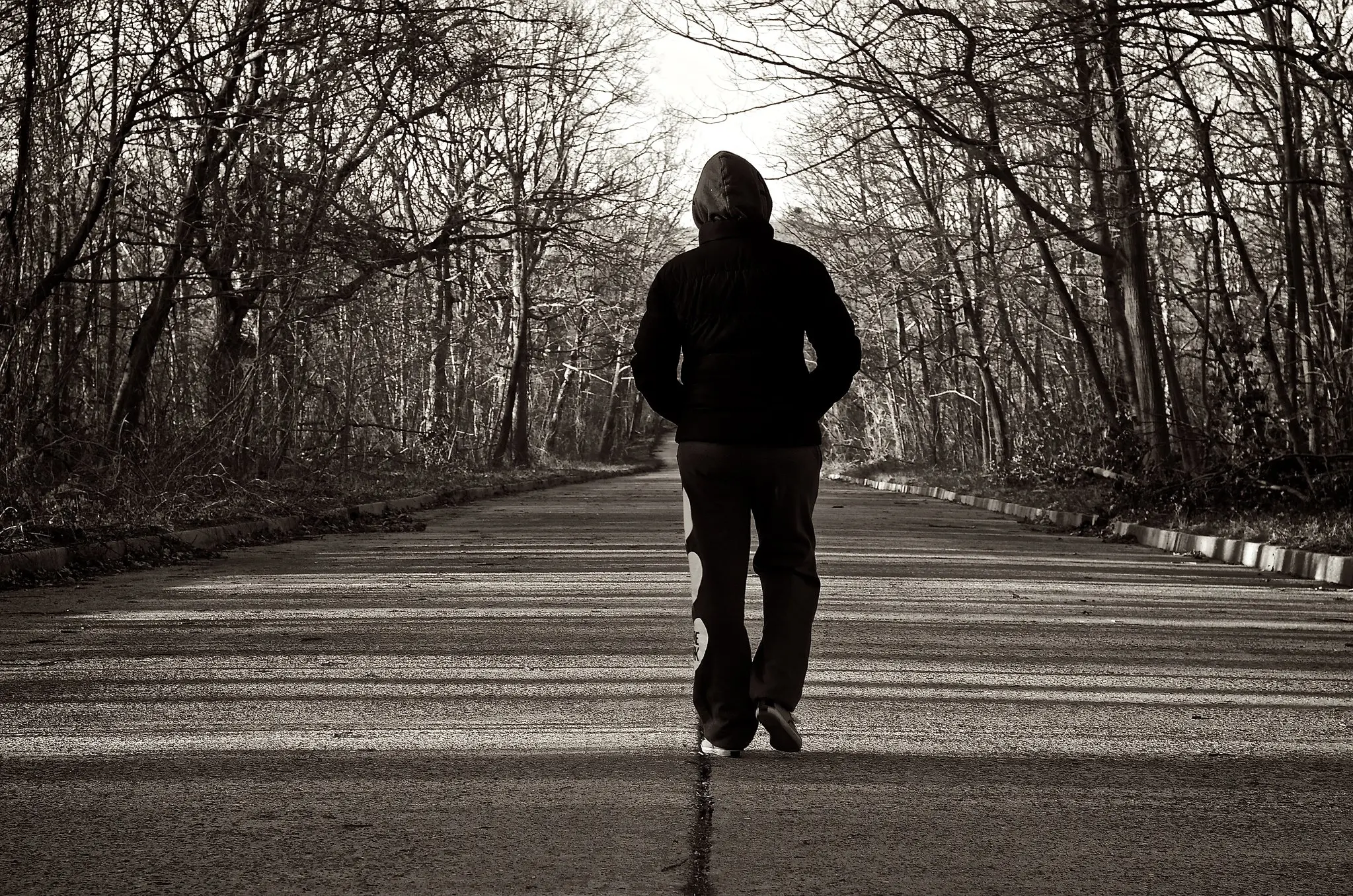 Man walks away with his back to the photographer.