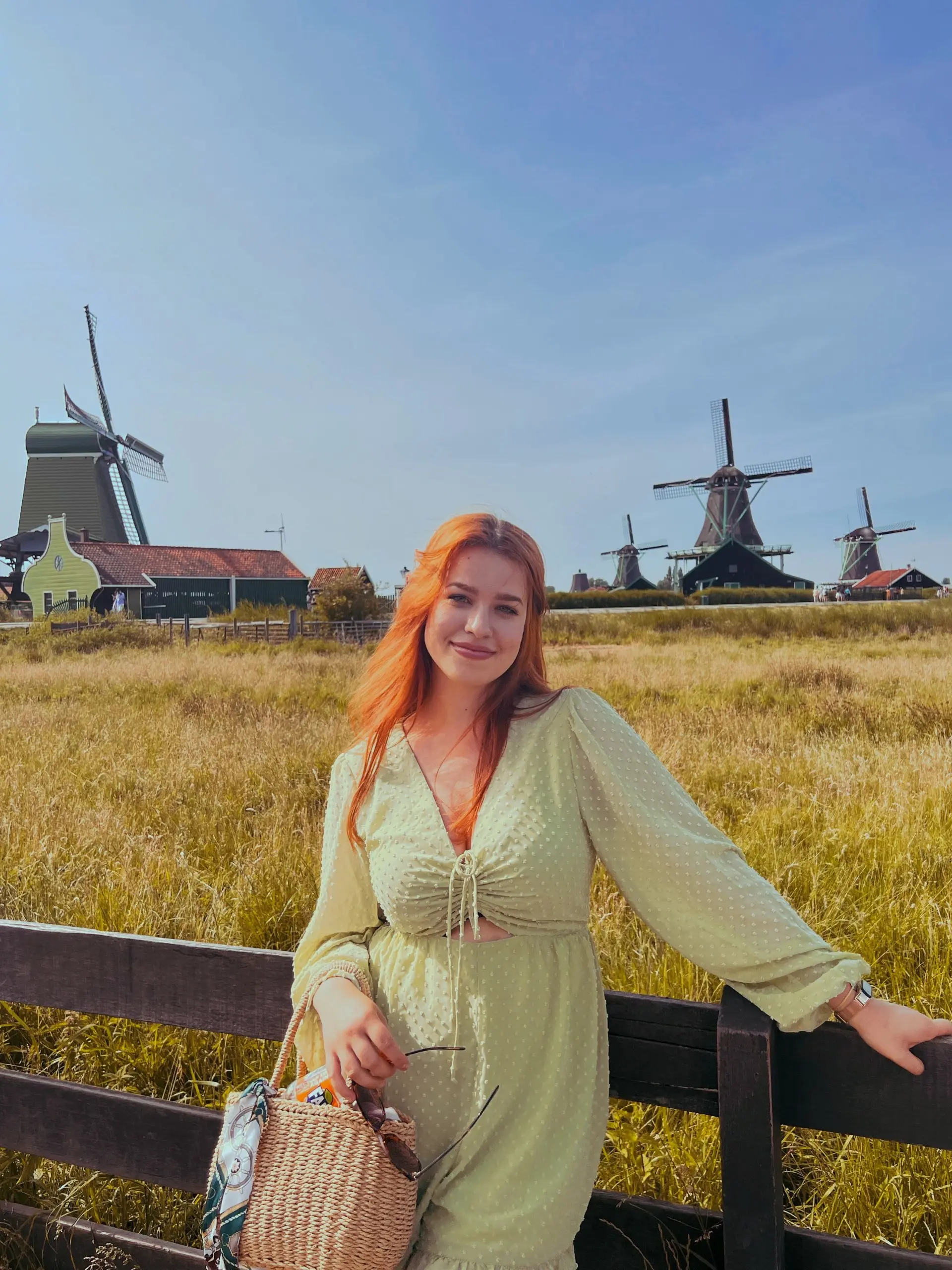 Alina poses in front of Dutch windmills
