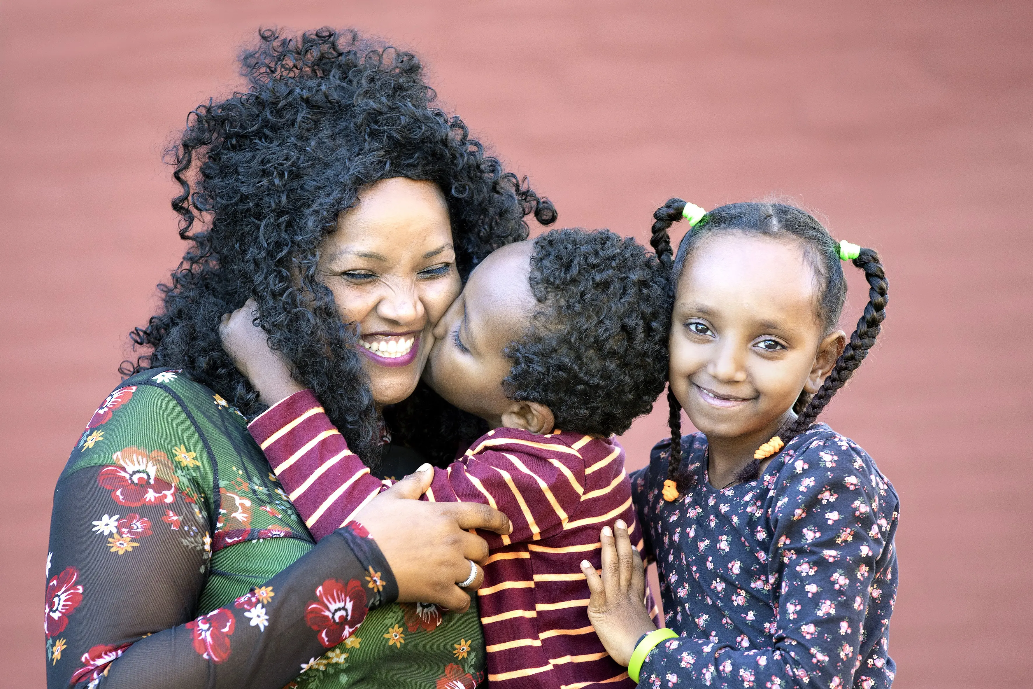 A mother hugs her children after family reunification.