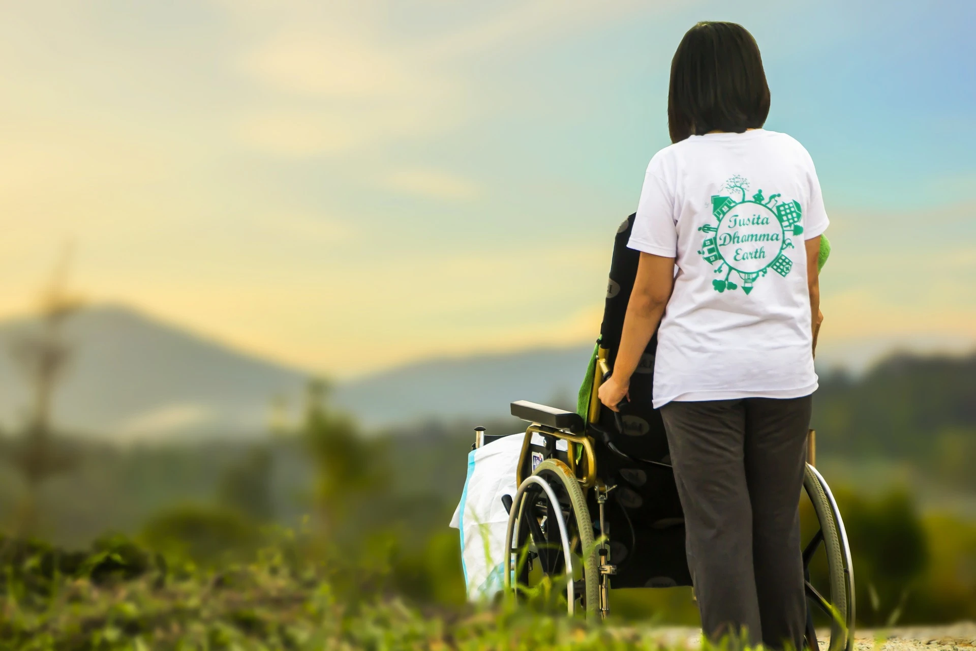 Person in wheelchair is helped 