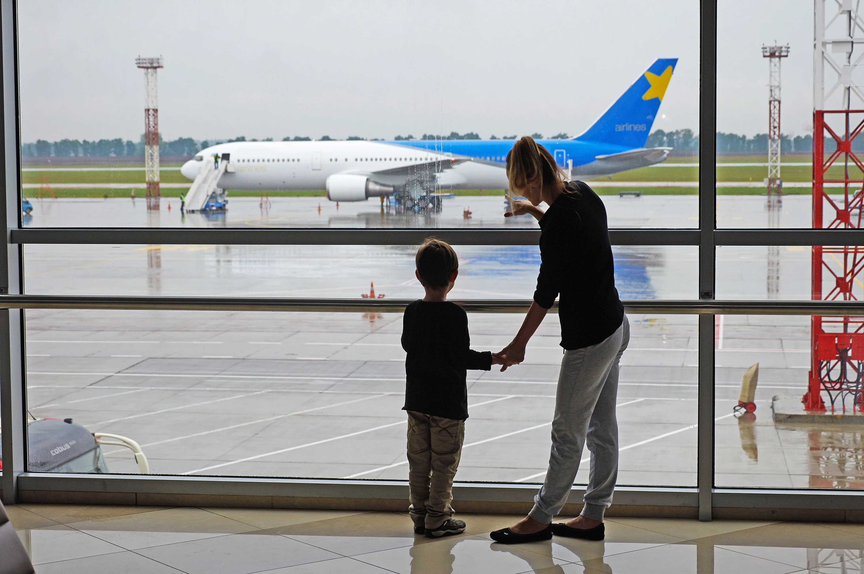 Woman with a child at an airport in/on the way to Ukraine.