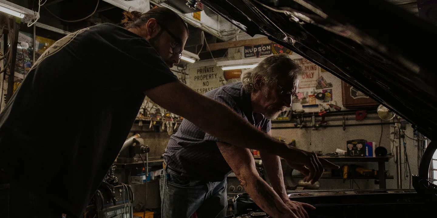 Mechanics managing work in a garage
