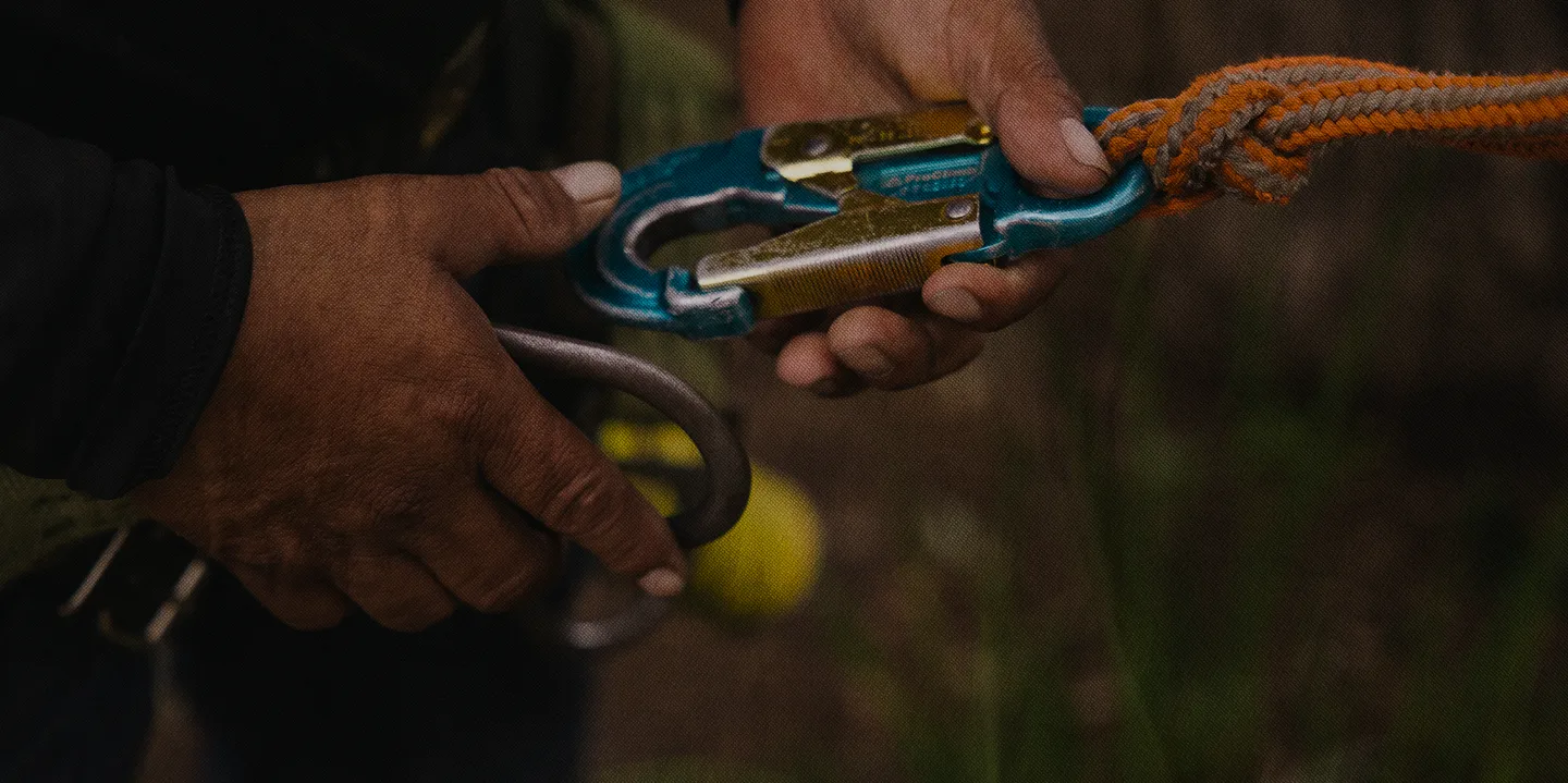 Hands securing field equipment