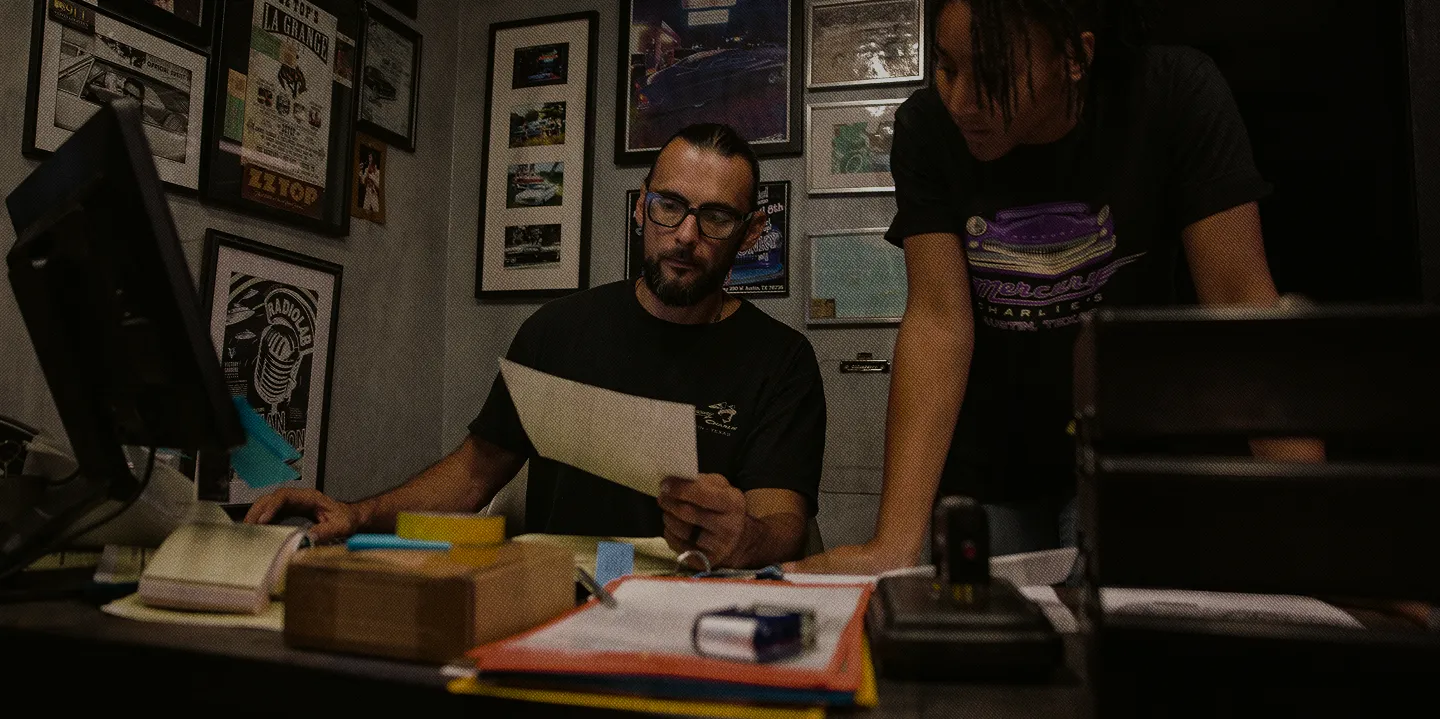Business owners reviewing accounts at a counter