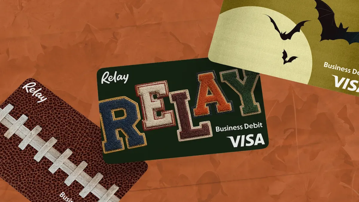 Green Relay Visa Business Debit card with colorful RELAY text on orange background with football and Halloween bats.