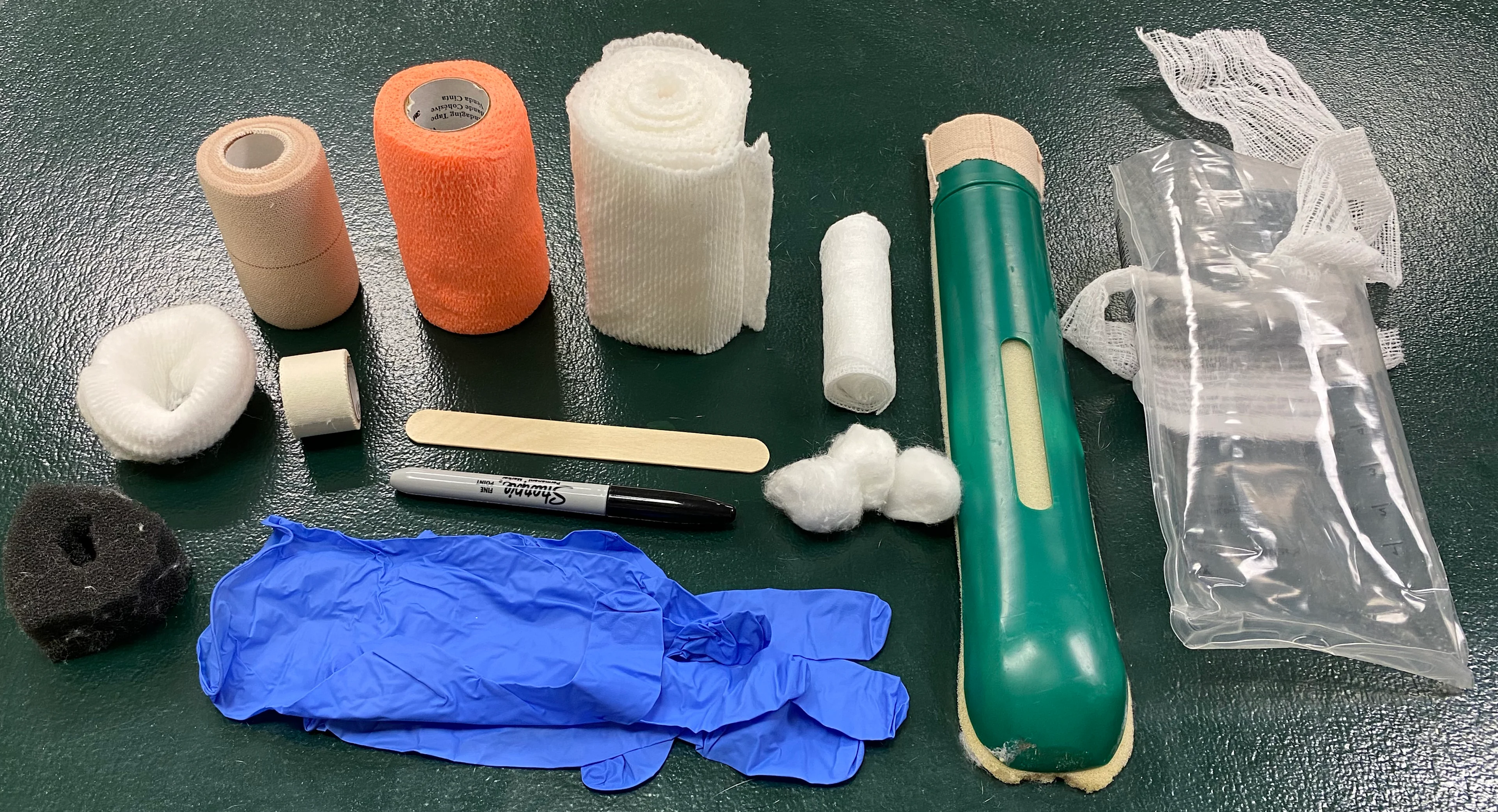 Materials needed for bandaging shown displayed on a table.