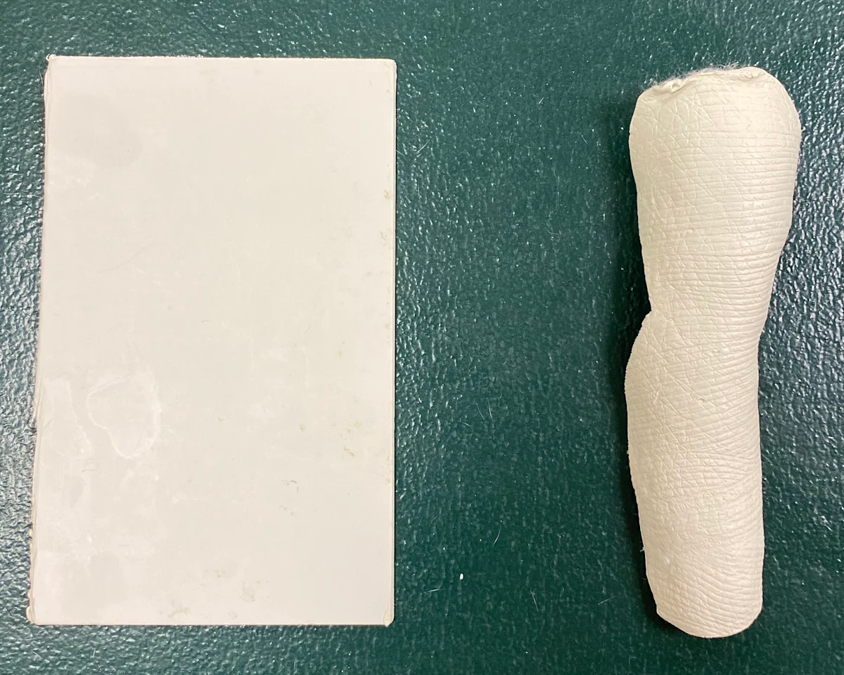 Splinting material shown as an unmolded sheet and in its molded form.