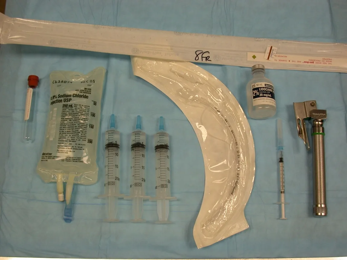 The supplies needed for bronchoalveolar lavage fluid collection are arranged on a surgical drape.