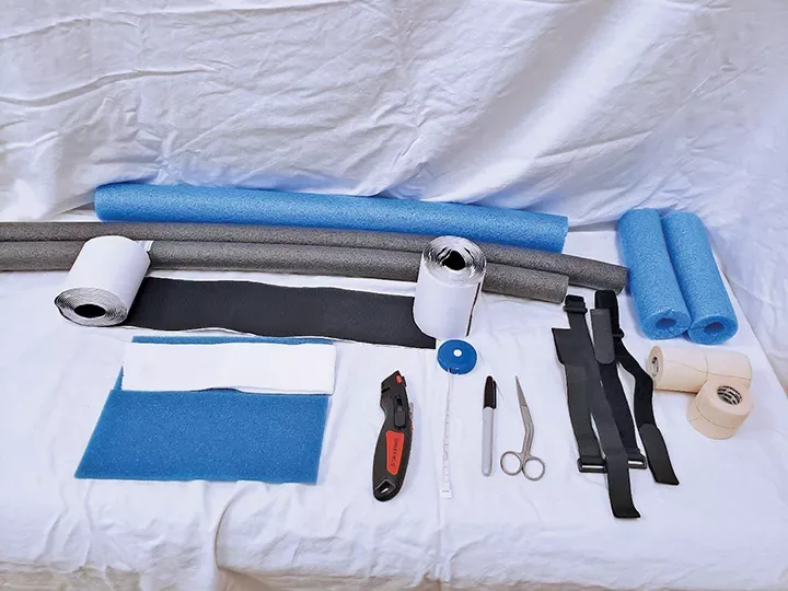 Supplies for bandaging a hydroma are laid out on a draped table. 