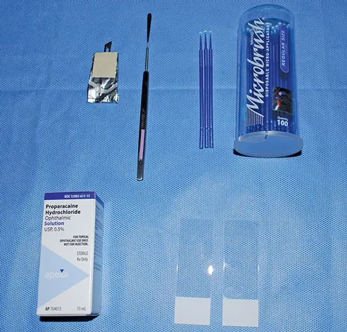 Equipment needed for collecting corneal and conjunctival samples for cytology displayed on surgical drape.
