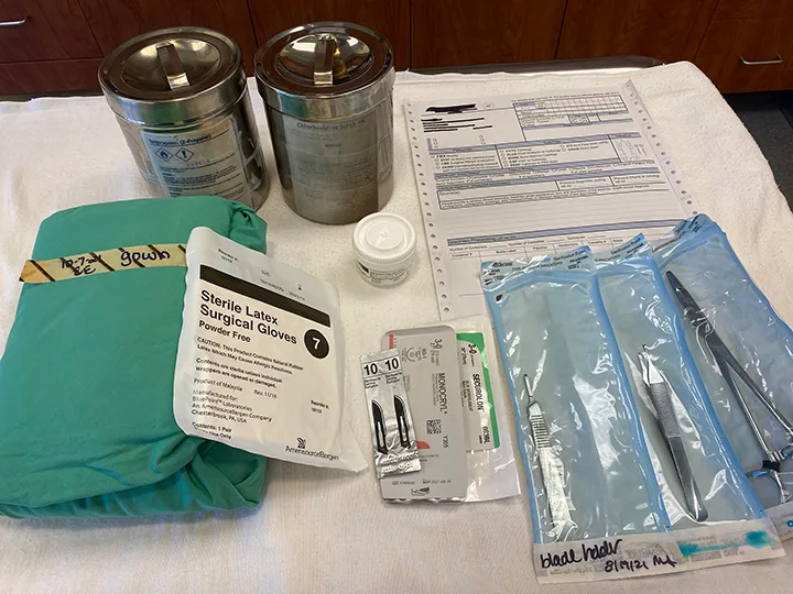 Display of surgical supplies needed to perform an incisional biopsy.
