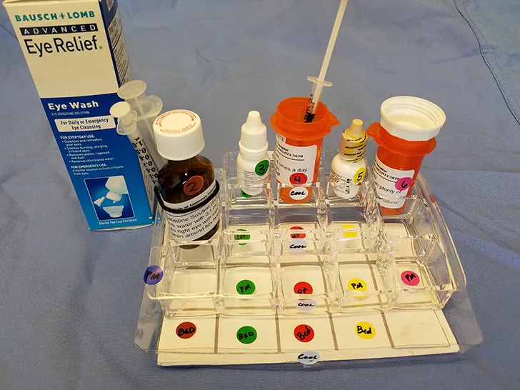 A compartmentalized medication tray with various medications.