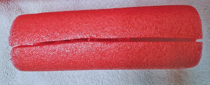 A section of a pool noodle has been cut lengthwise.