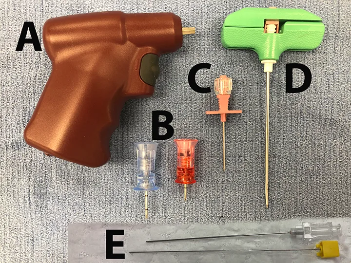 Equipment needed for intraosseous needle placement laid out on surgical drape.