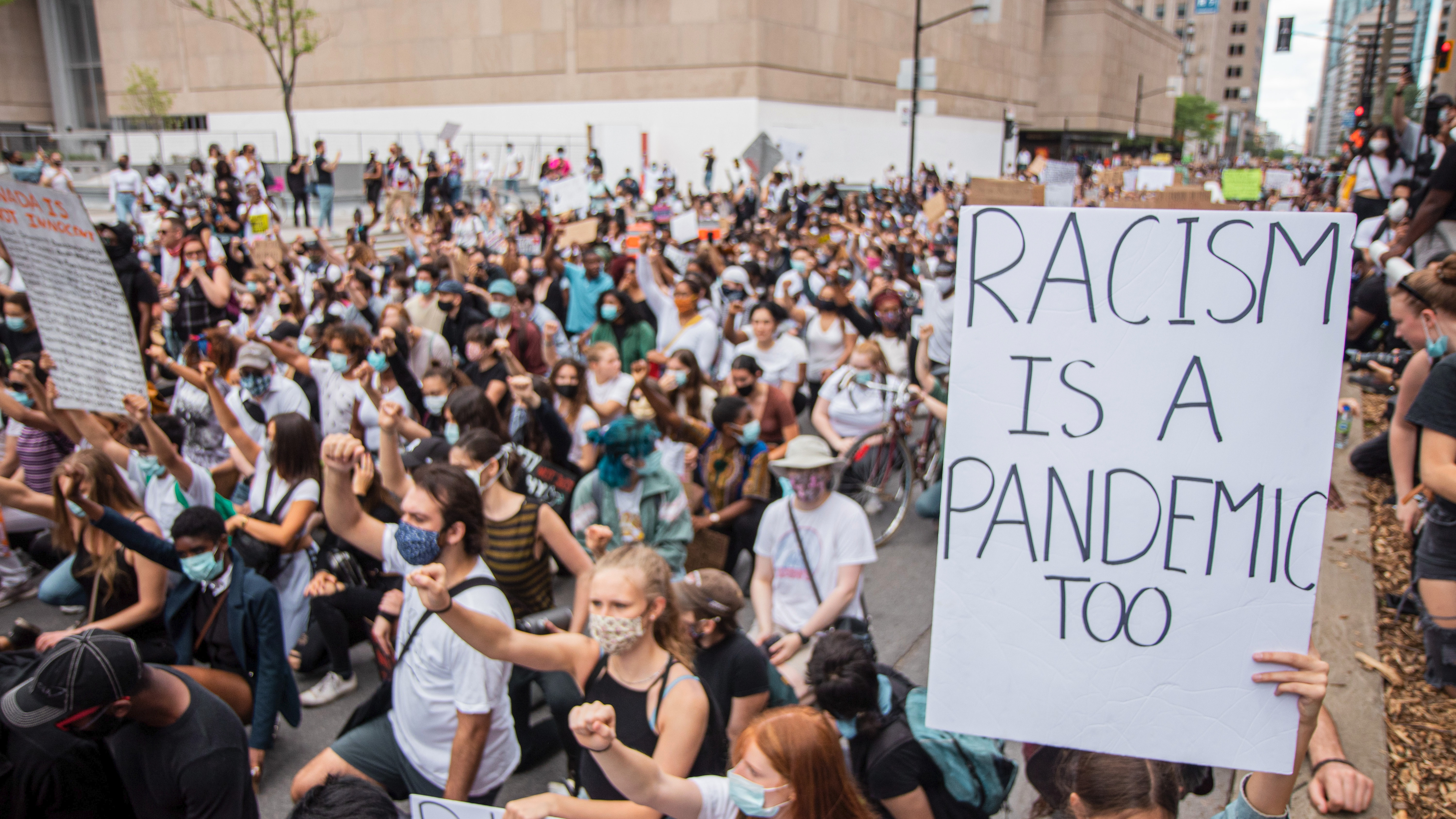 Racism Is a Pandemic Too Demonstrators Wearing Masks