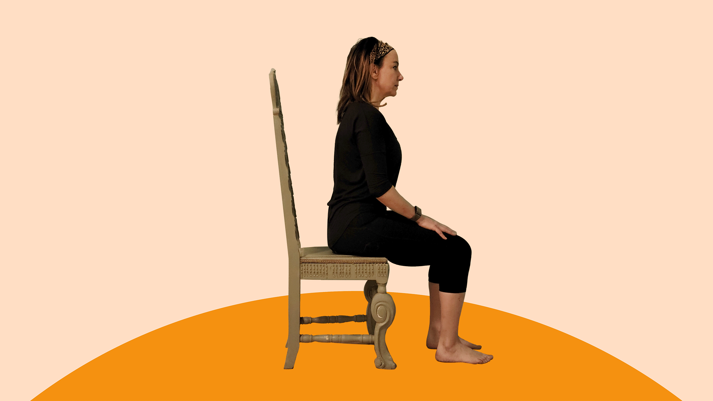 A woman does calf raises exercises on a chair. 