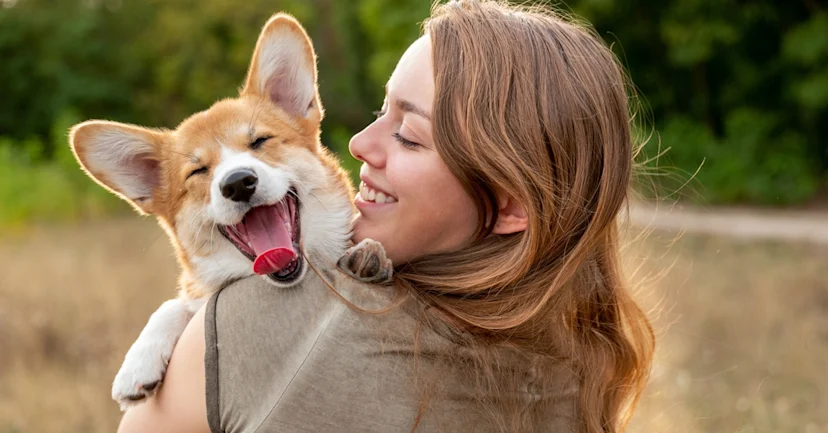 Woman holding happy dog