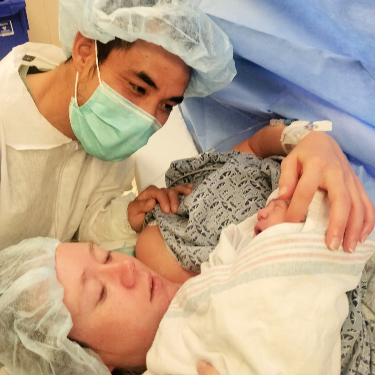 Clare Hennig is pictured in the delivery room with her husband and newborn son.