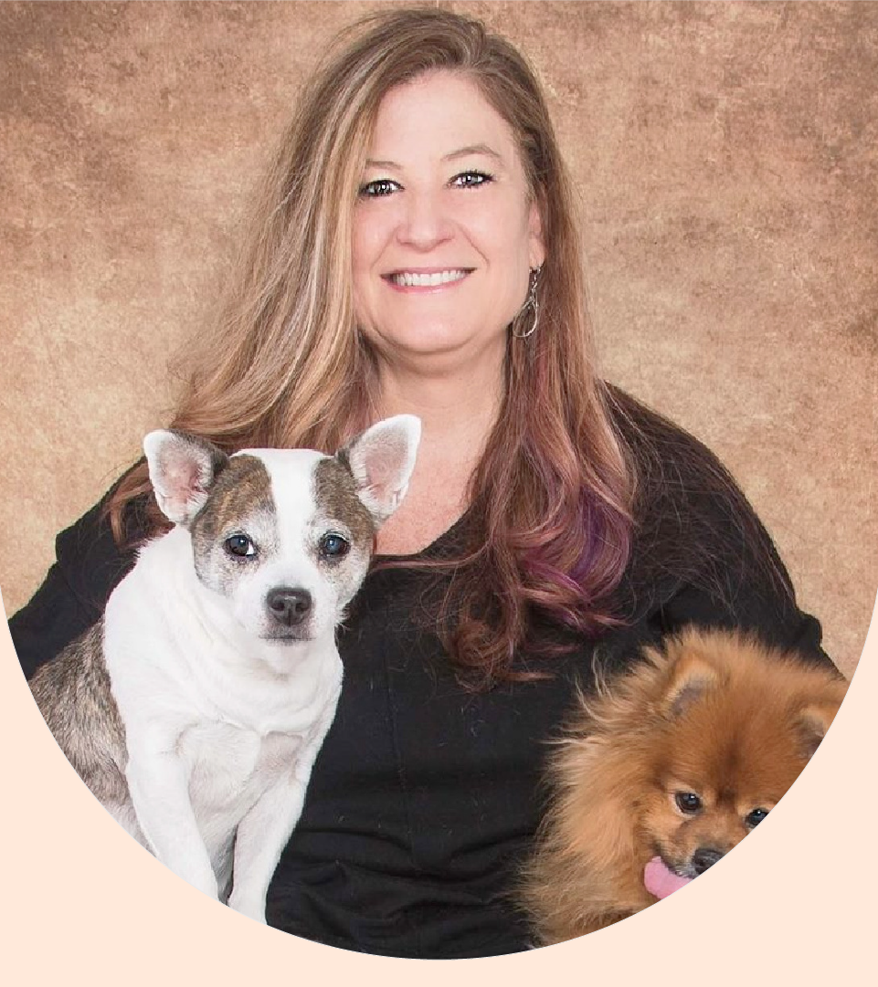 Lisa Binns is pictured in a headshot with two of her dogs.