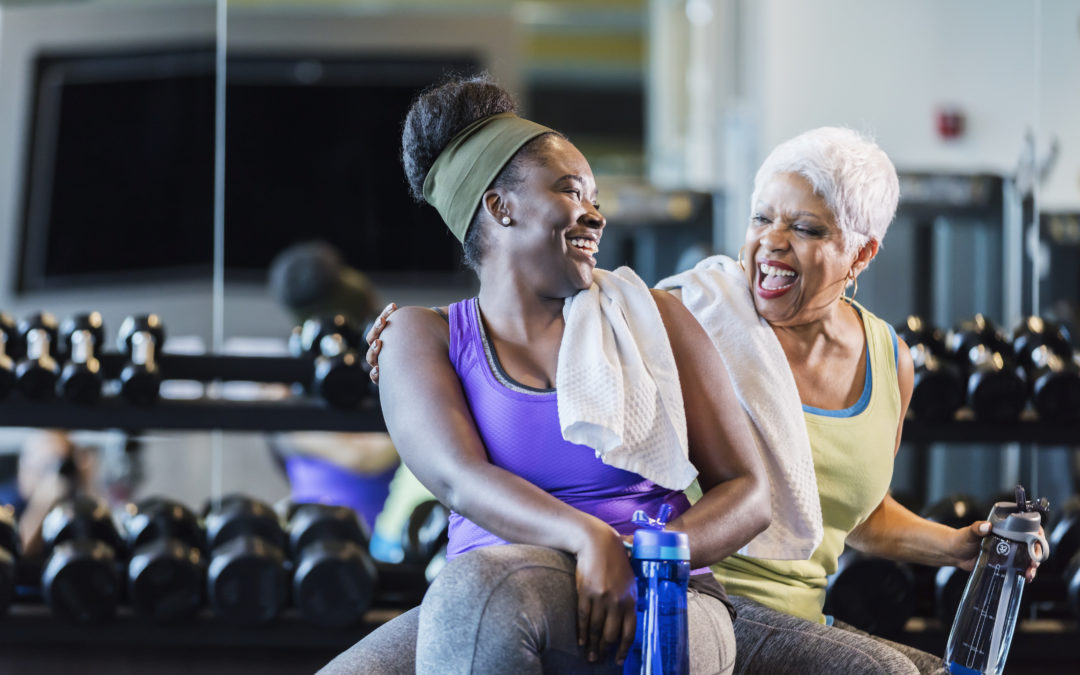 A woman and her mom working out at the gym and are discussing if heart disease runs in their family