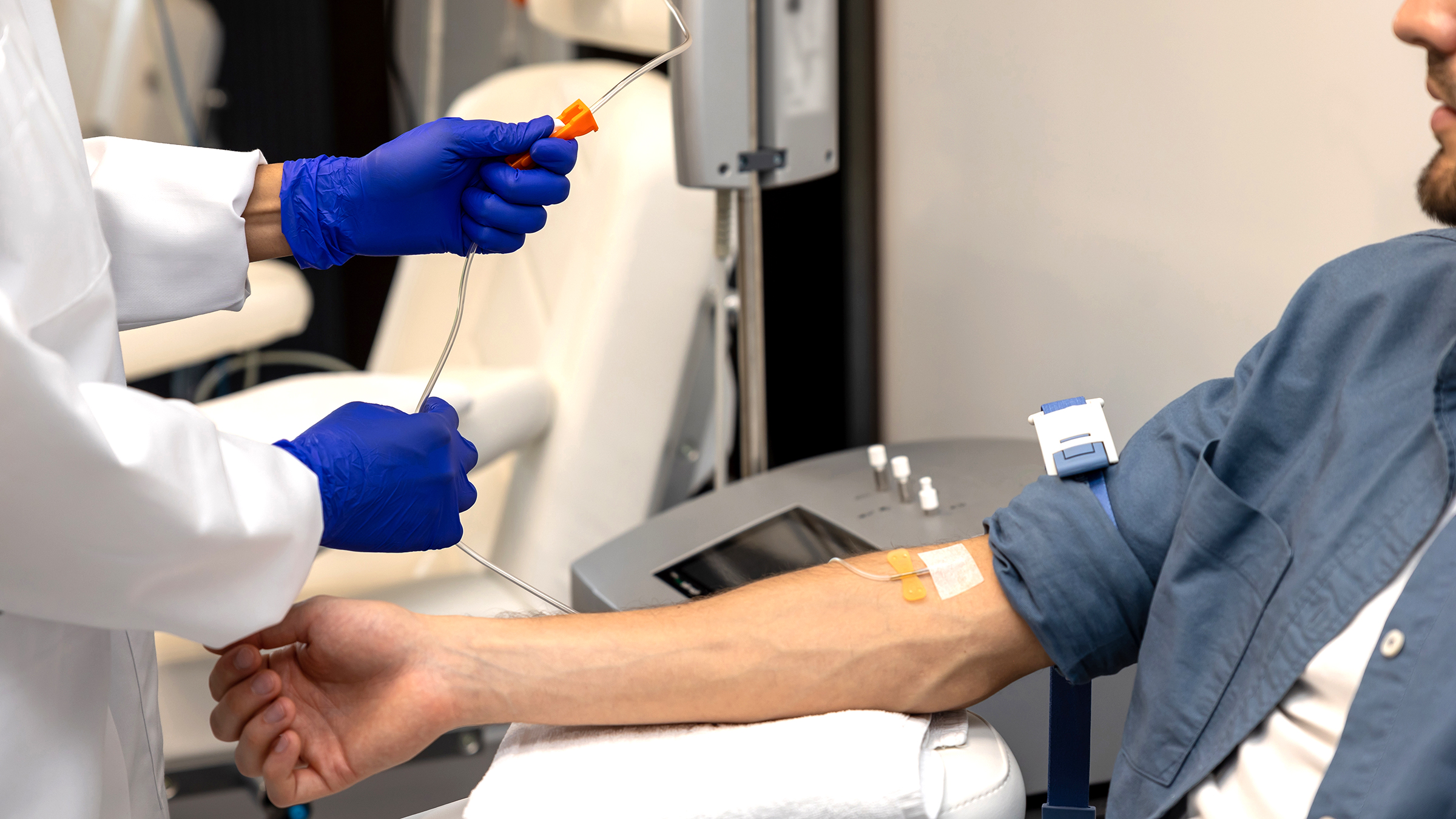 Close-up of catheter/vein in patient during blood draw or infusion procedure in clinical setting