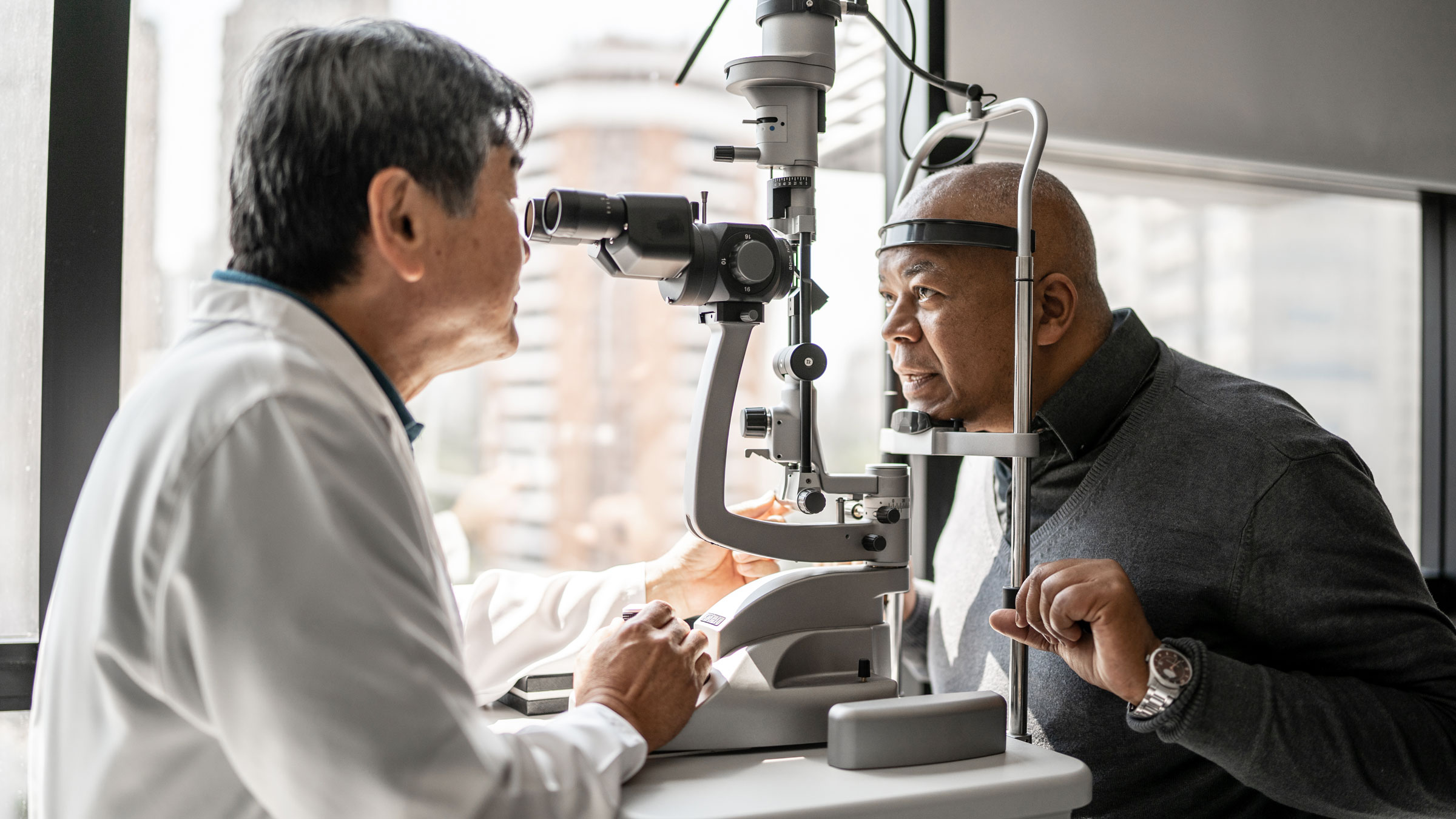 Health: Macular degeneration: ophthalmologist examining patient 1343839265