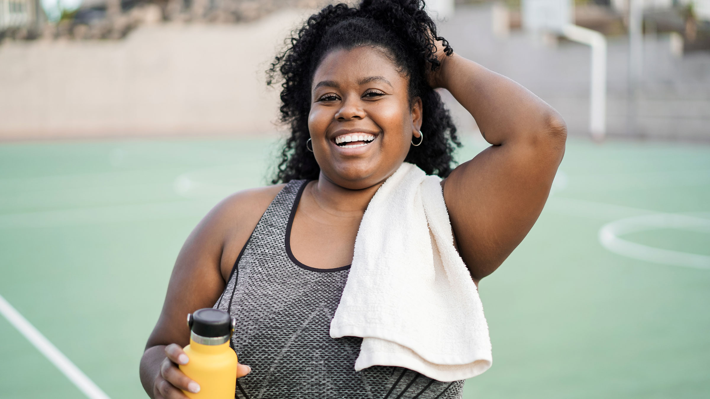 Woman smiling at camera doing workout morning routine outdoors.
DisobeyArt/iStock via Getty Images Plus