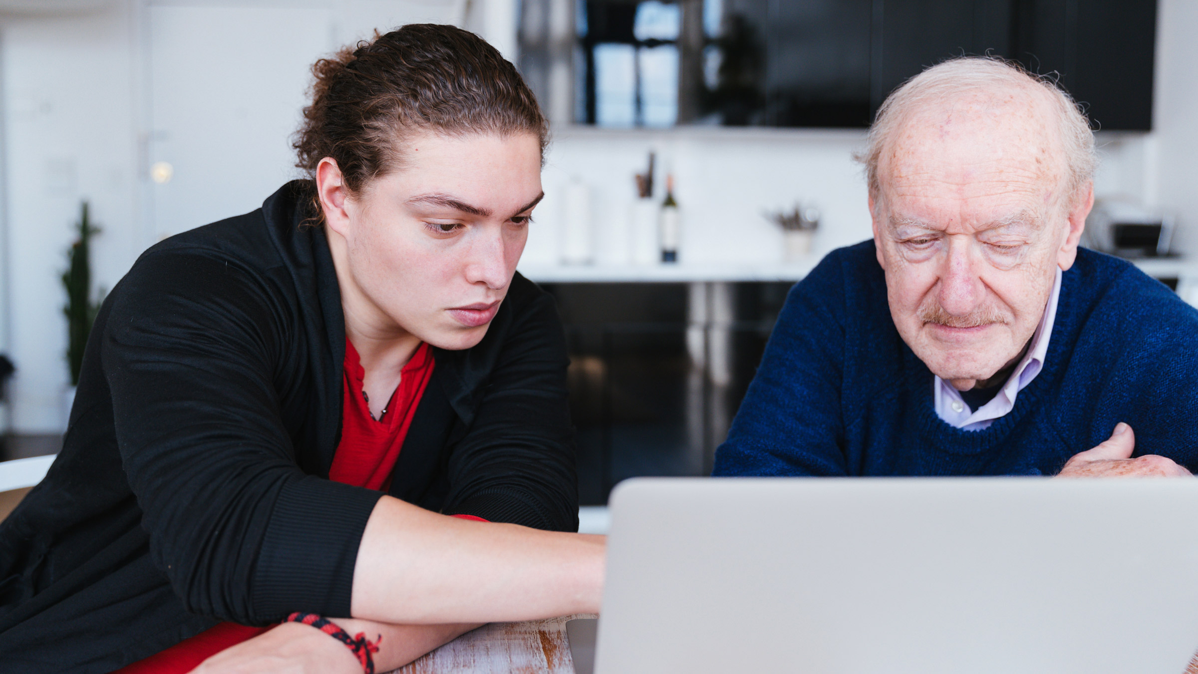 Medicare: young adult helping grandparent with laptop 1371126555