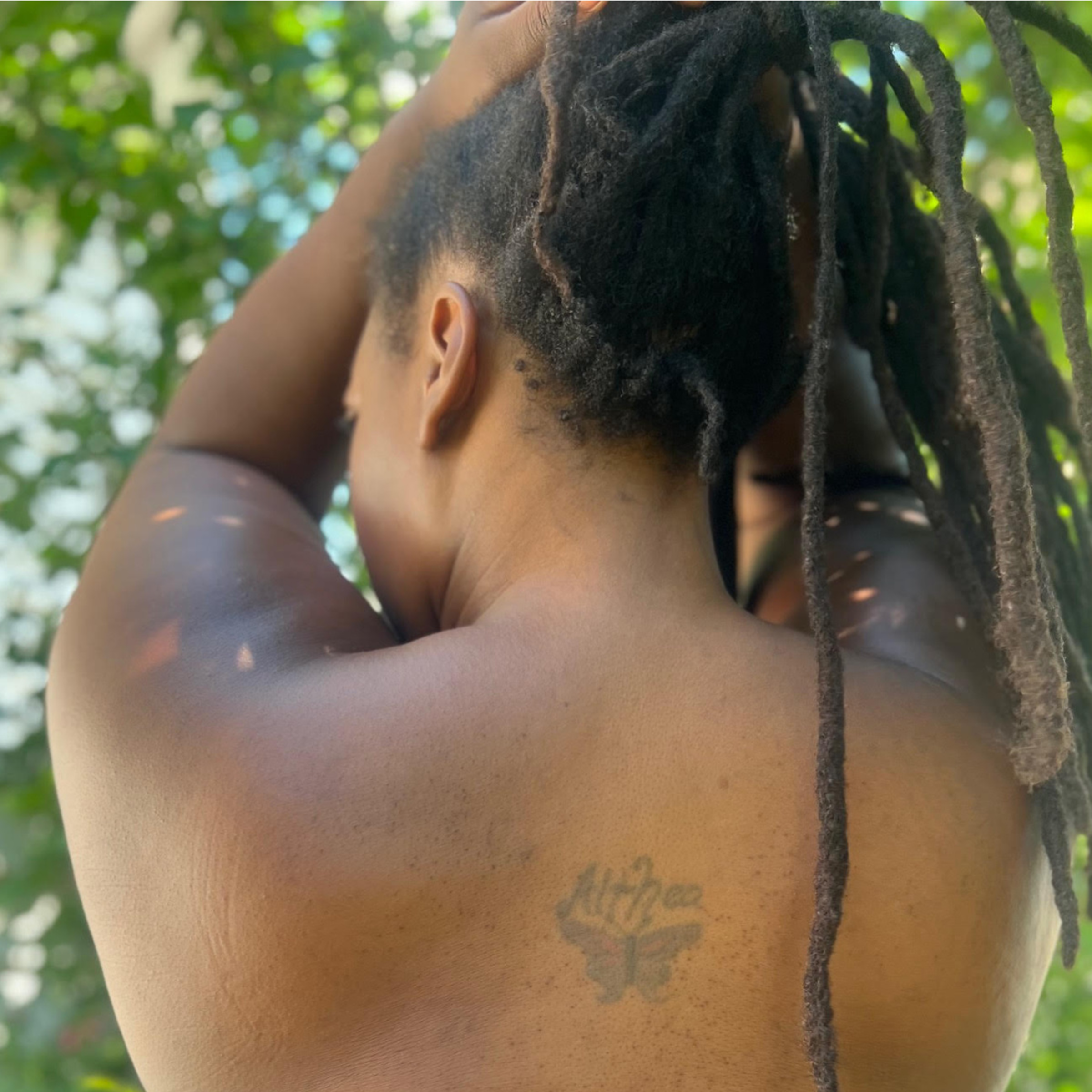 A detail shot of Althea Smith’s back tattoo, with her name and a butterfly design, is pictured.