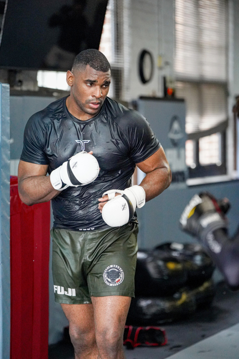 Jordan Morgan is pictured wearing boxing gloves while practicing mixed martial arts.