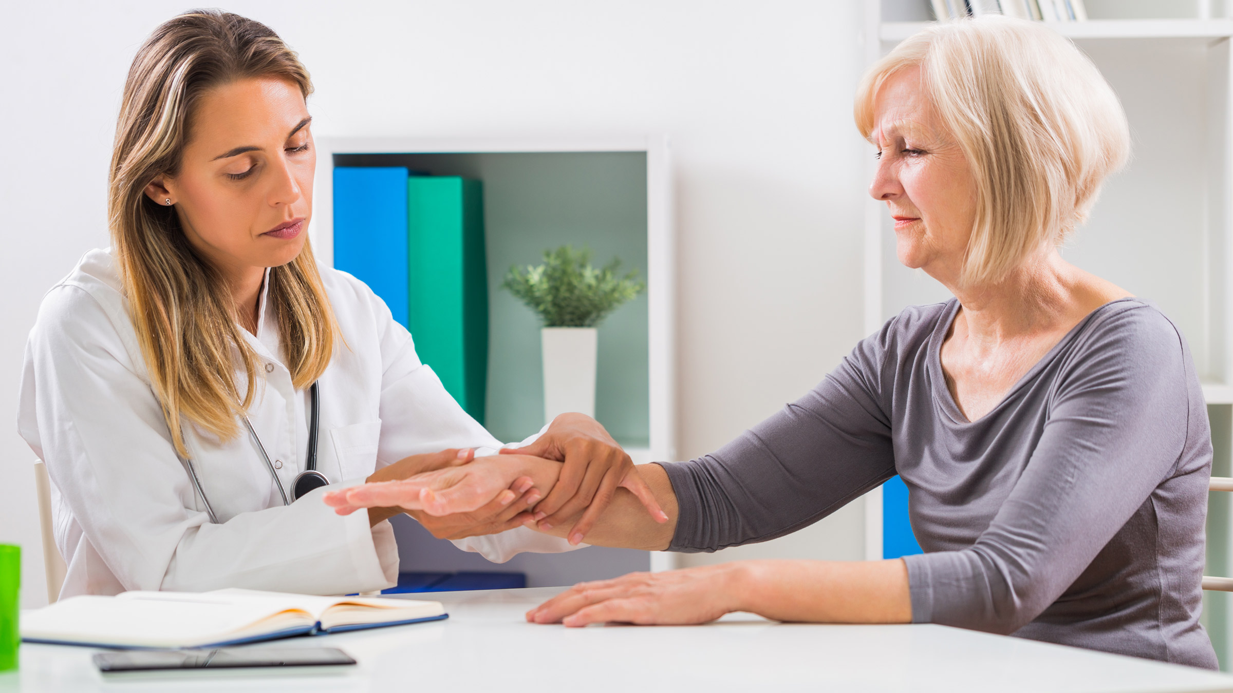 A doctor examining a patient's wrist.
LittleBee80/iStock via Getty Images Plus 