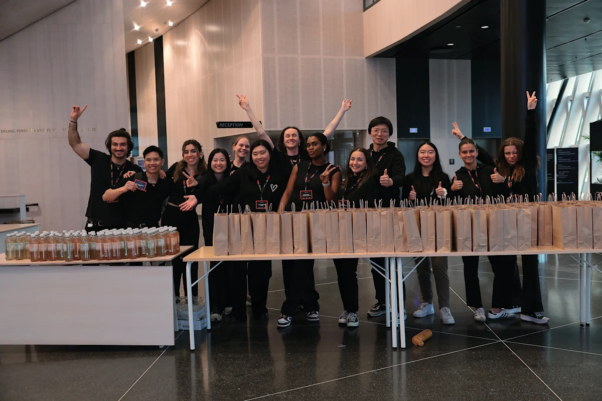 TEDxKI Crew standing behind a table full of gift bags.