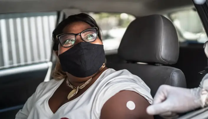 Woman in car getting vaccination