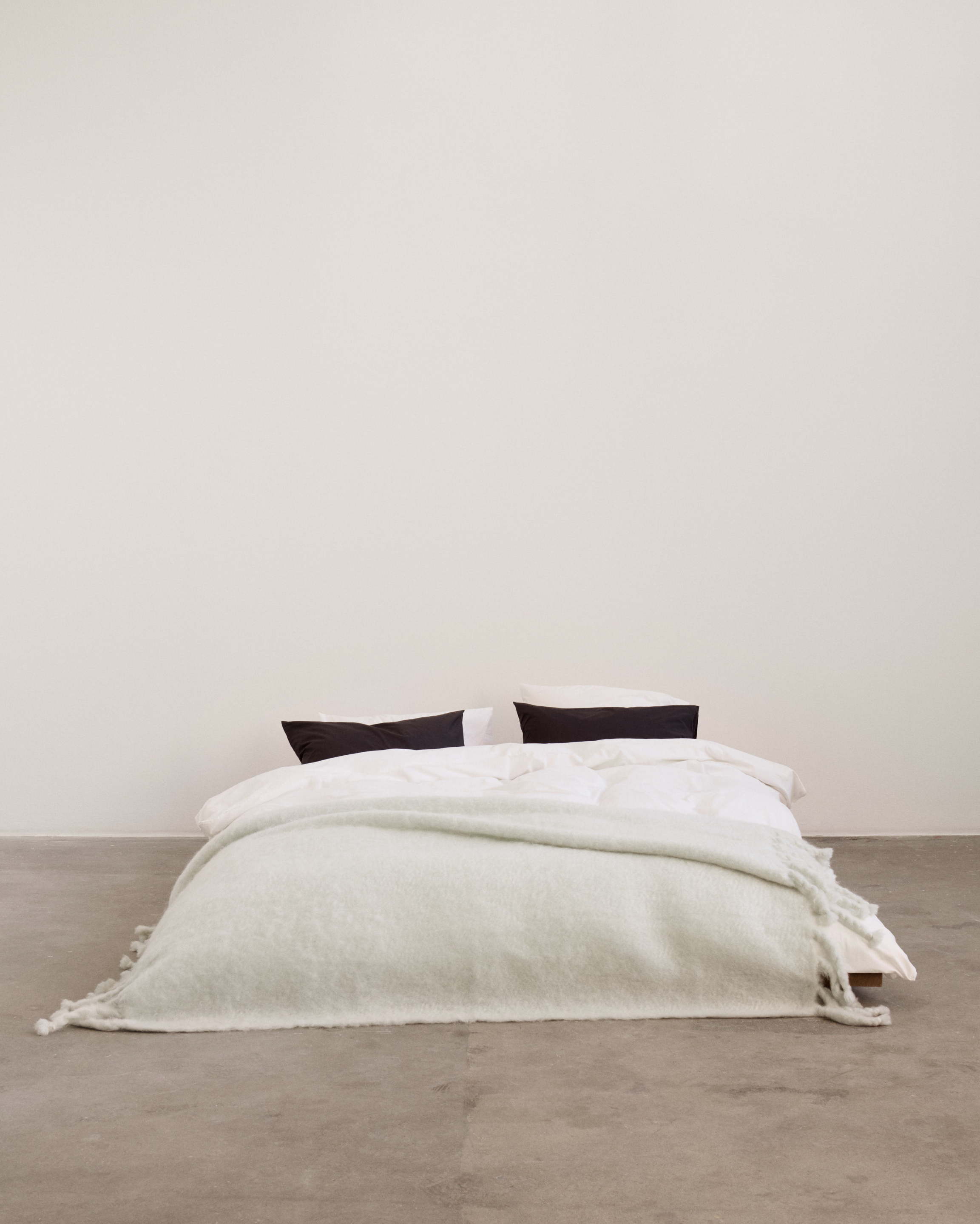 Gris mohair blanket paired with Cream White and Ash Black bedding
