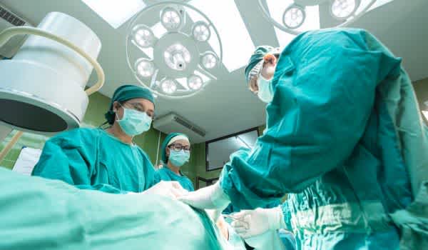 surgeons under cms team model and value based healthcare performing a surgery