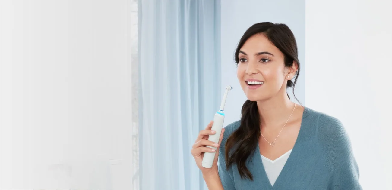 cepillarse los dientes con el cepillo de dientes elAcctrico Oral-B