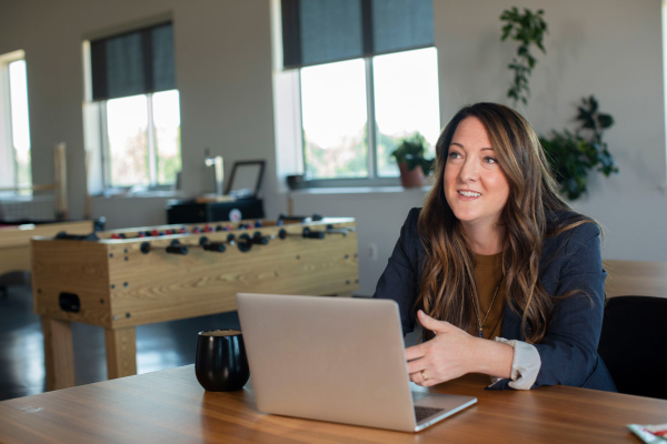 Woman speaking to clients in leasing center