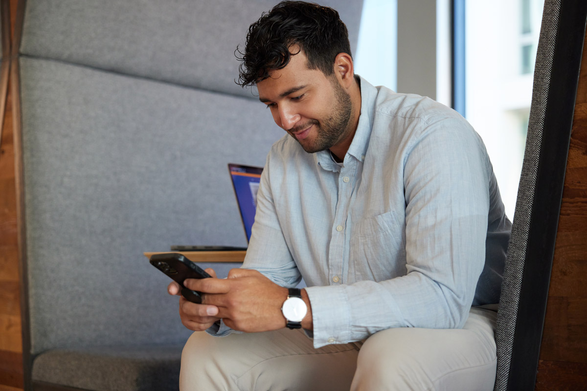 Man using phone to pay bill through tenant portal