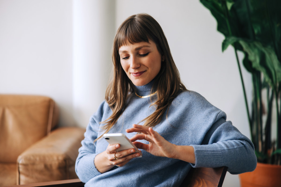 Woman smiling at phone