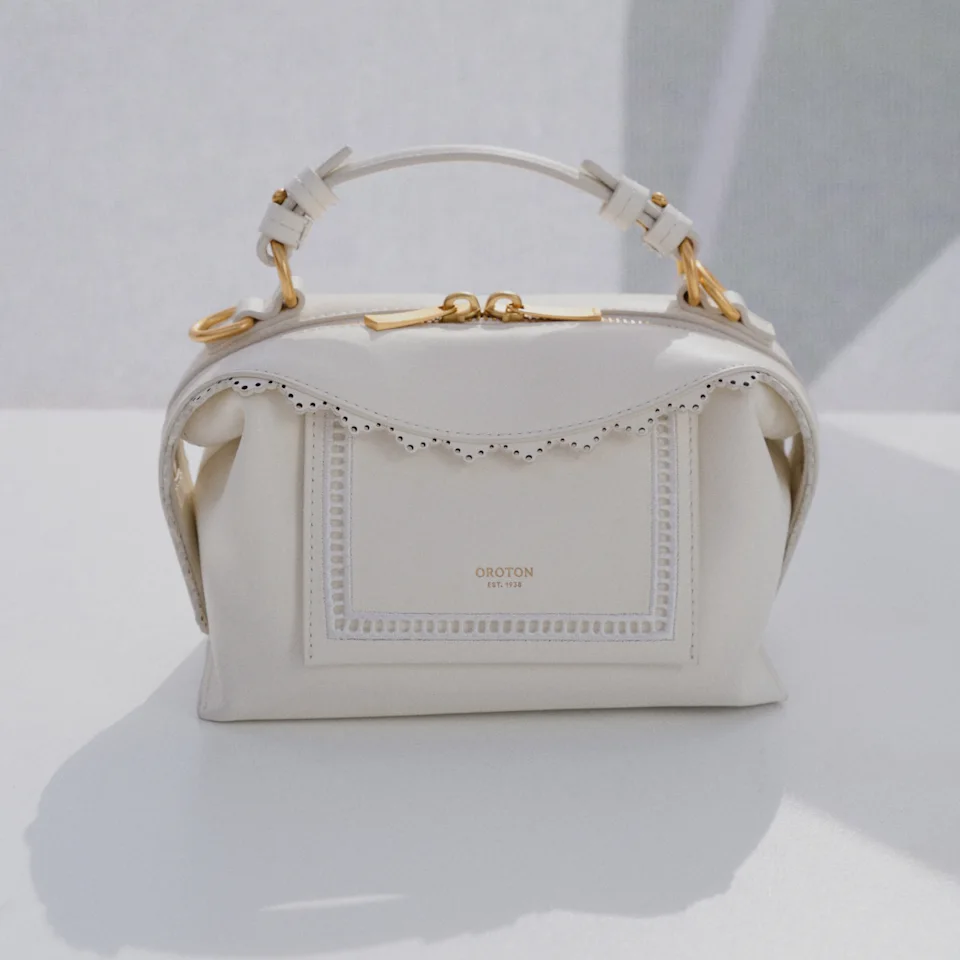 Cream leather Mica top handle bag with a scalloped trim