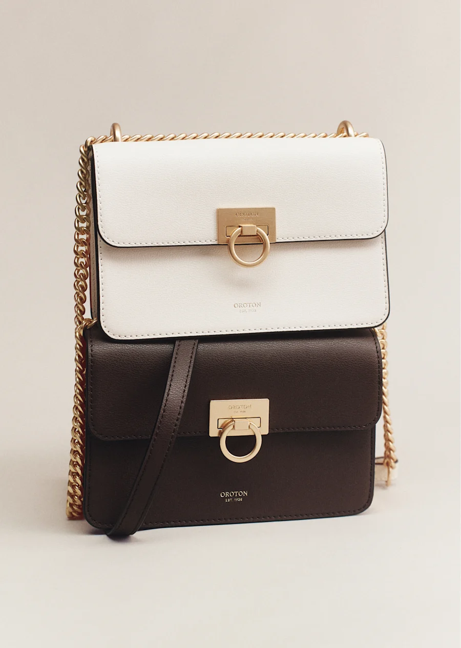 Cream and dark brown leather bags with gold turn-locks and chain straps