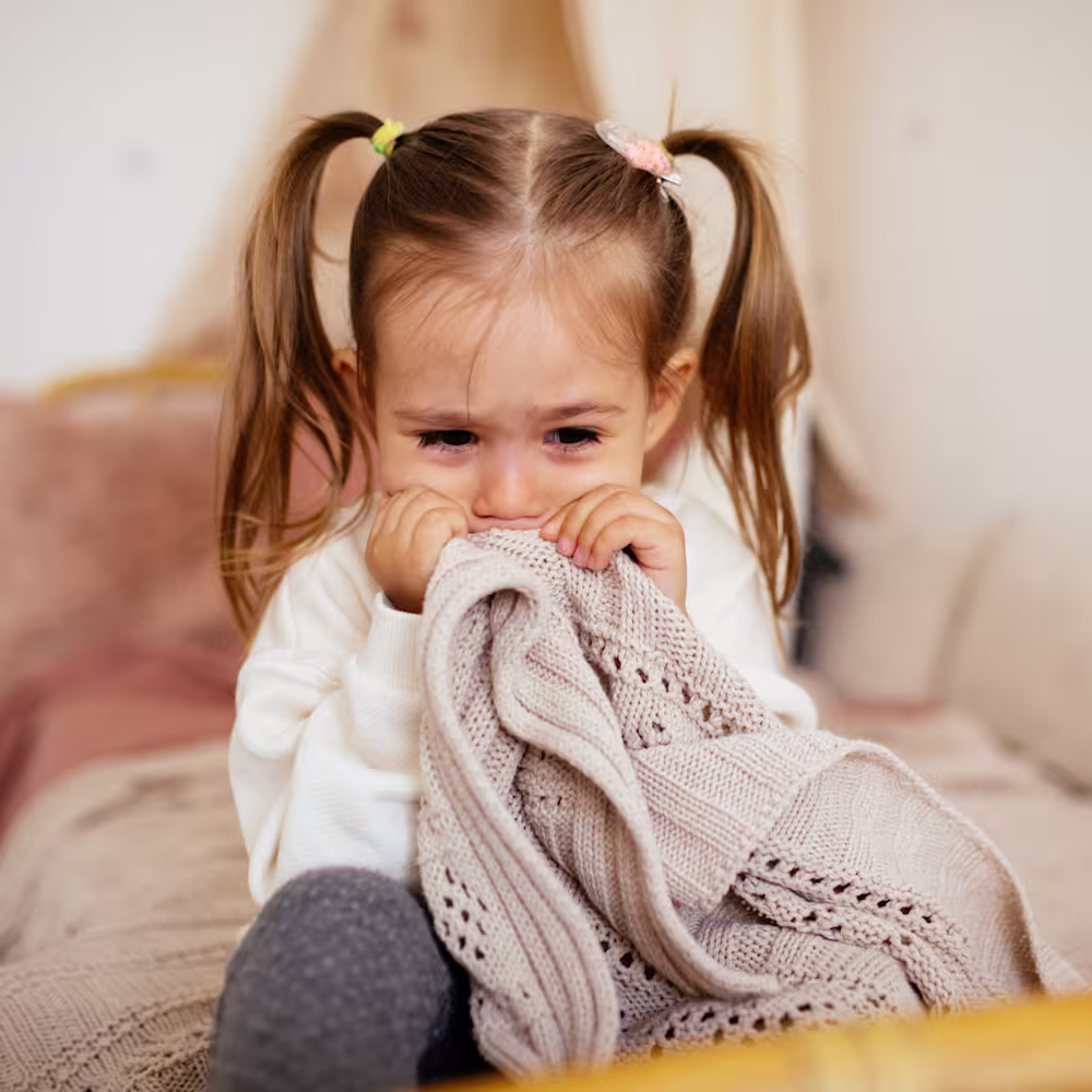 Little girl scared in bed.