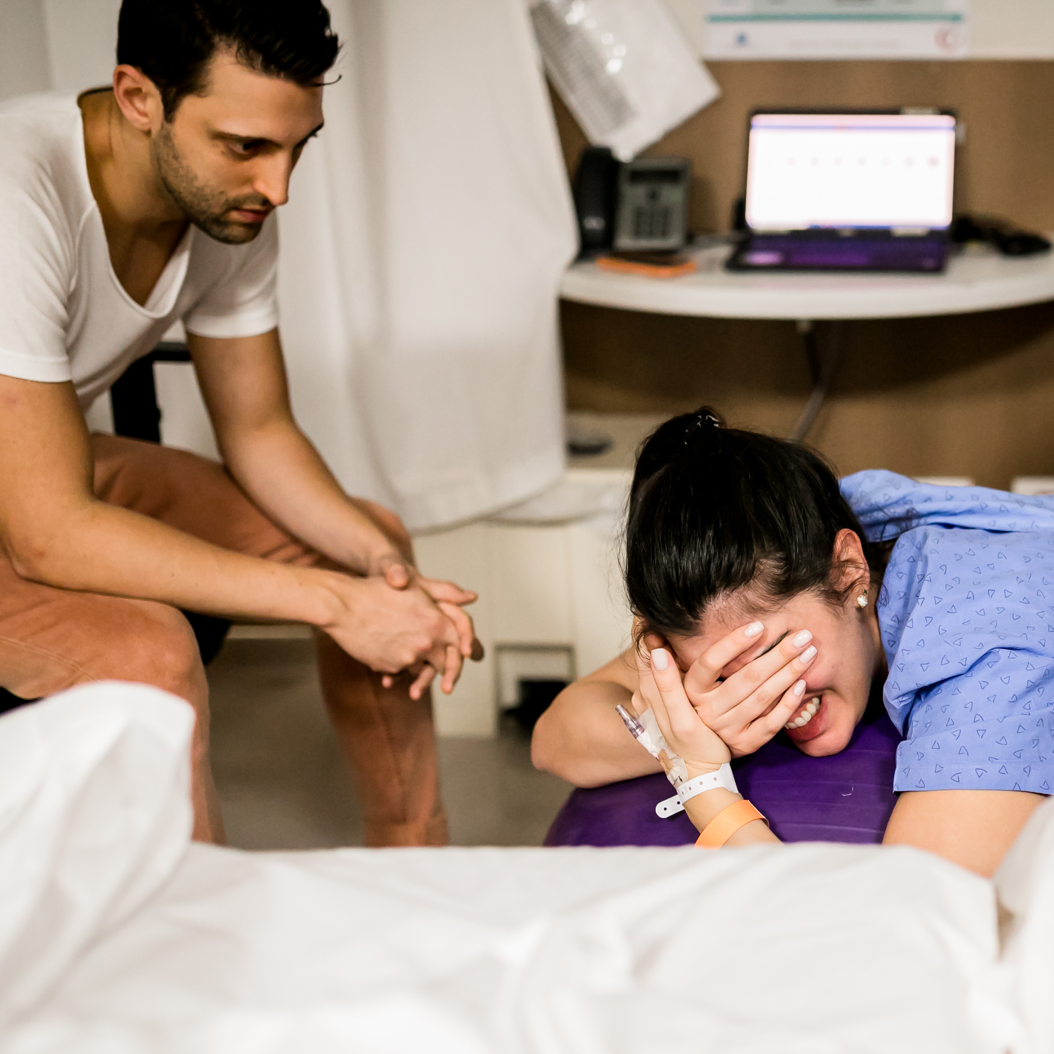 Woman with birth partner in delivery room