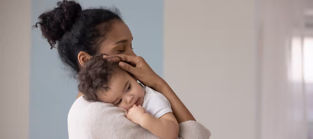 Baby separation anxiety: Baby crying while mother carries her