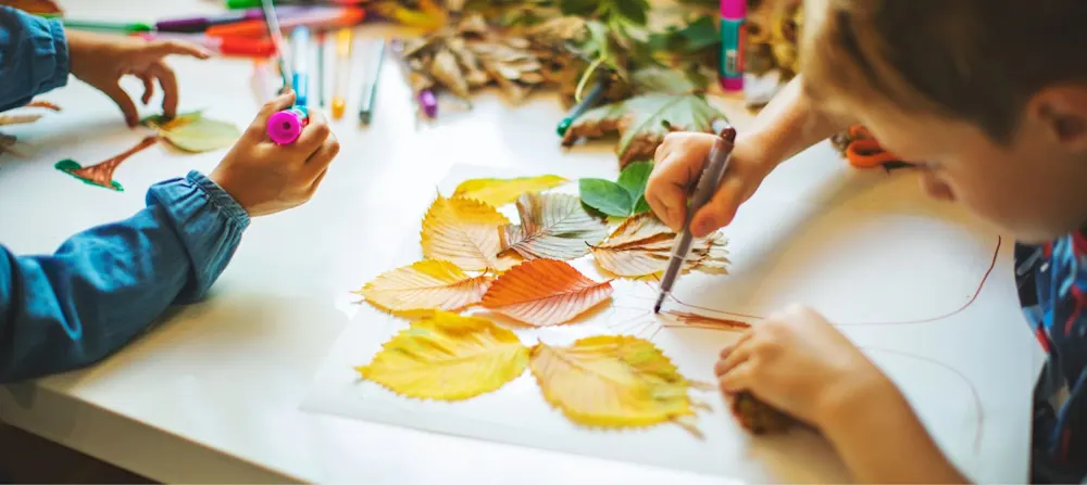 Children painting leaves.